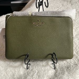 Brand new never used. Olive green medium leather wristlet.